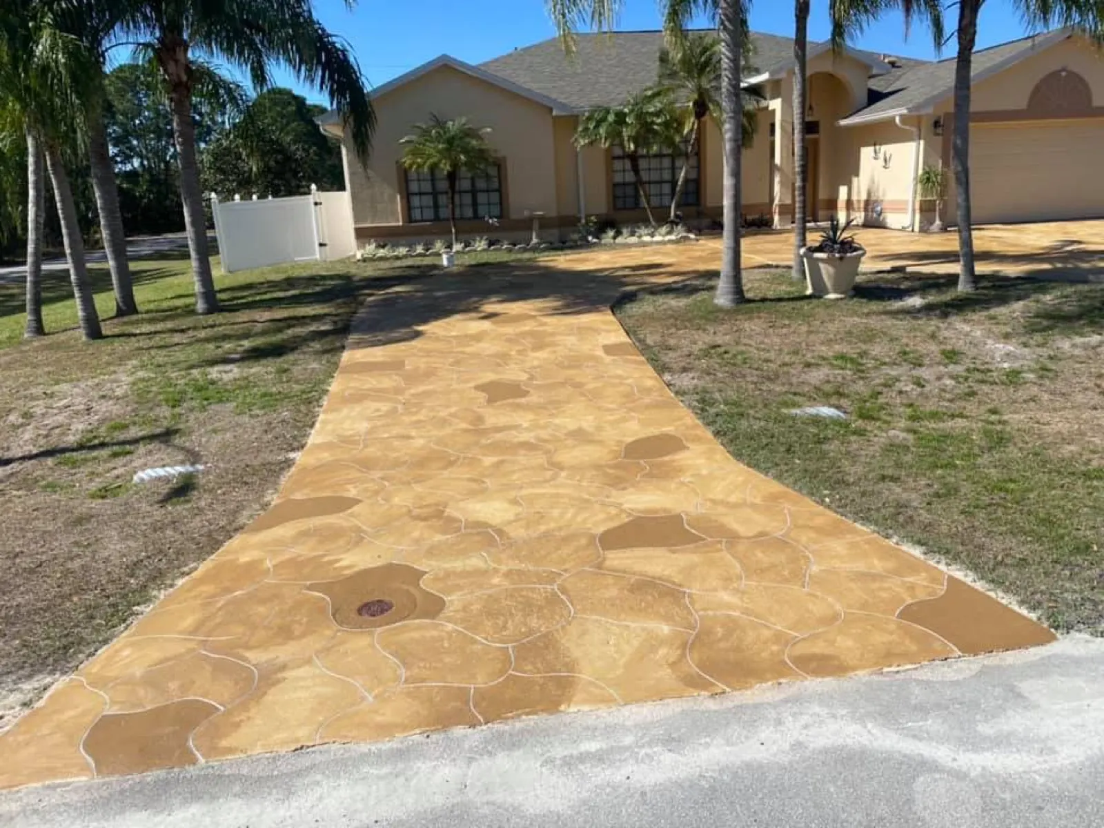 Flagstone pattern stamped concrete walkway with stain