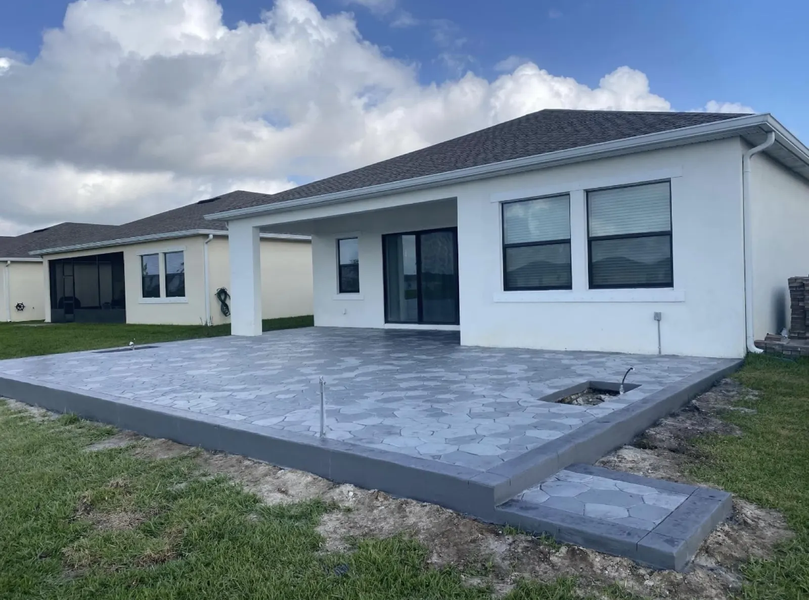 Gray paver patio installation in progress