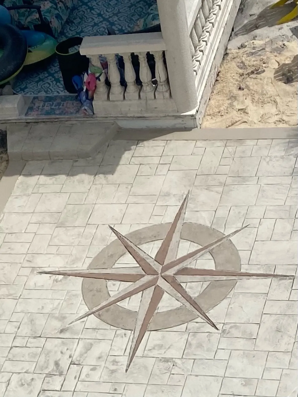 Hand-carved compass star in a stamped concrete patio, Brevard County FL