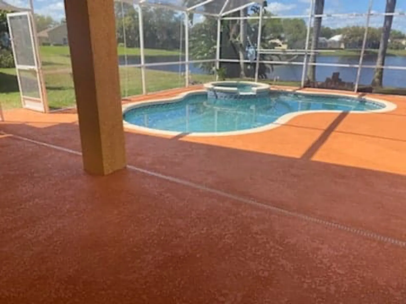 Orange pool deck coating at a canal front home
