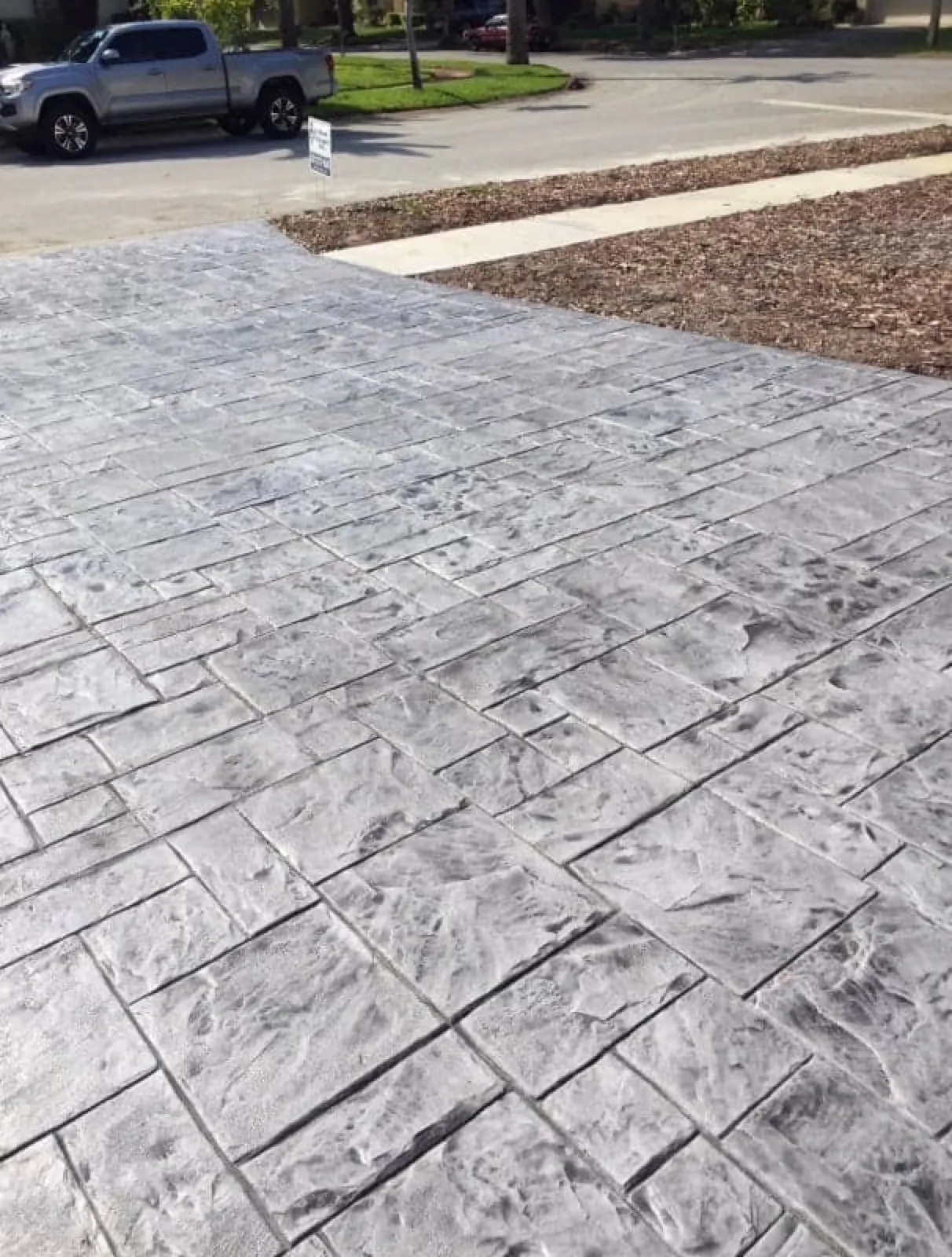 Resurfaced pool deck and spa inside a screen enclosure